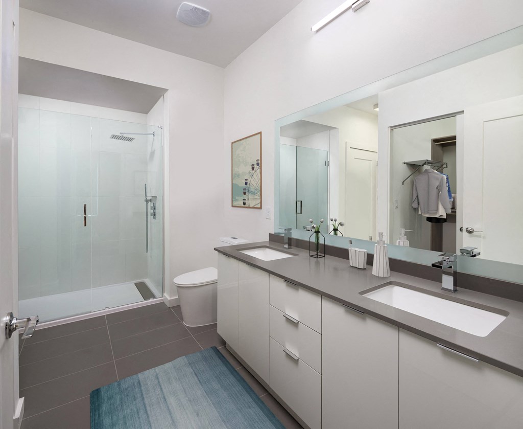 a bathroom with a large mirror and two sinks a bathroom with a large mirror and two sinks at SLX Atlanta, Georgia, 30341